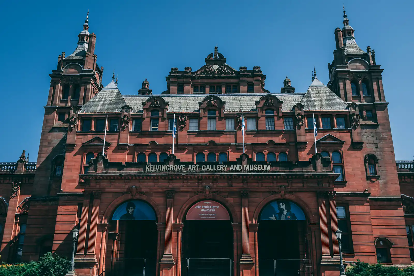 The red sandstone towers of Kelvingrove Art Gallery and Museum, Glasgow West End, under a blue sky